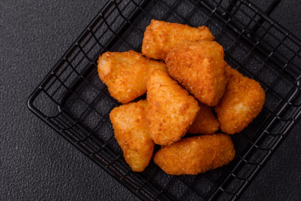 Breaded camembert or brie cheese baked in the form of nuggets with salt and spices