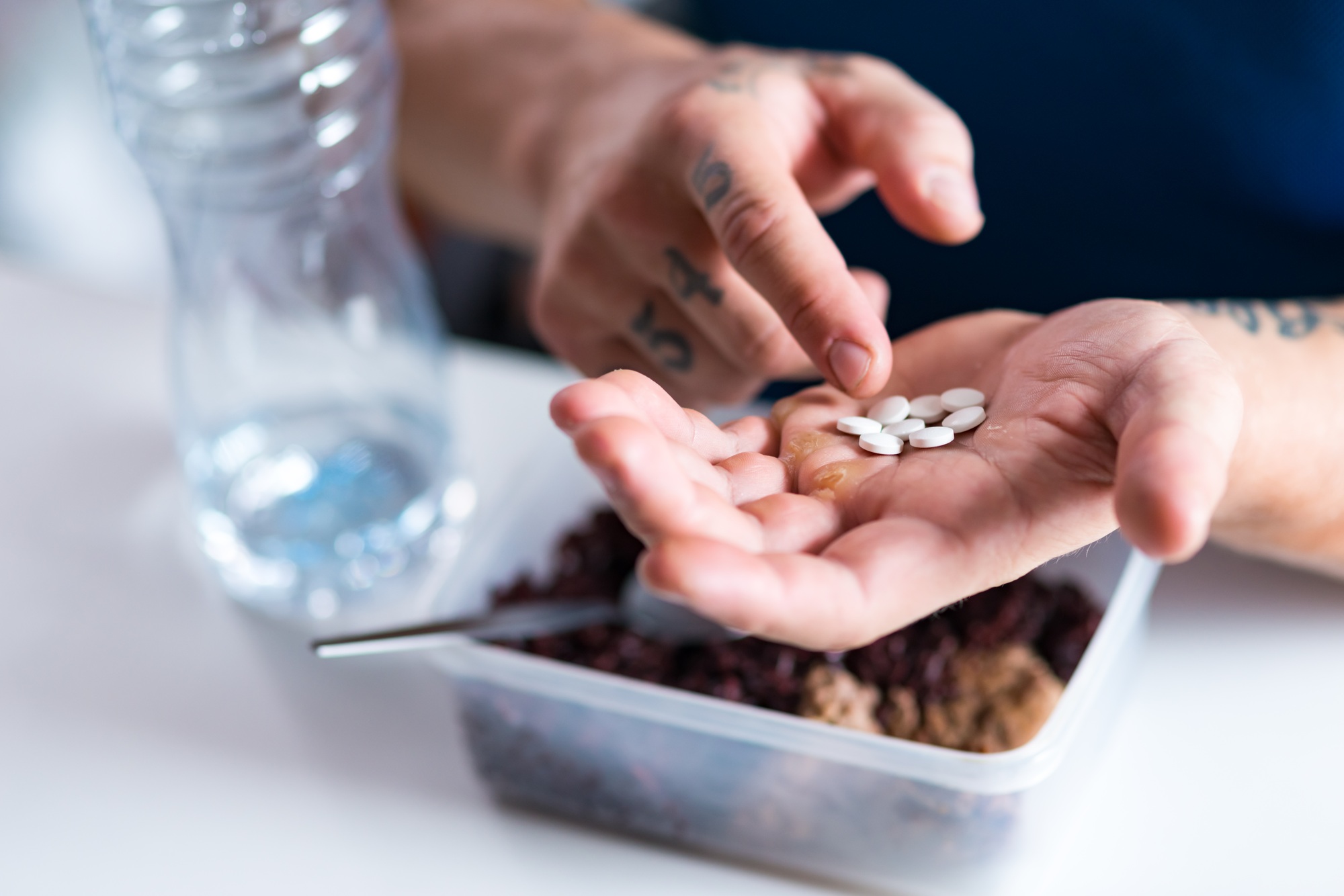 Close up of pills in hands of a professional strongman