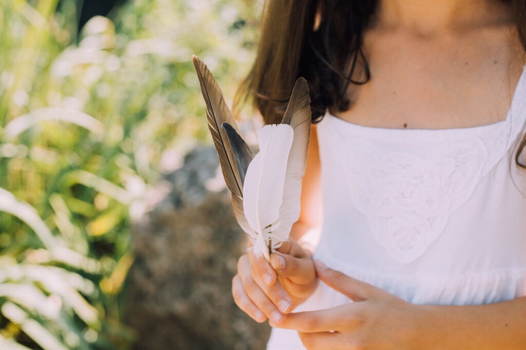 Girl with feathers in white