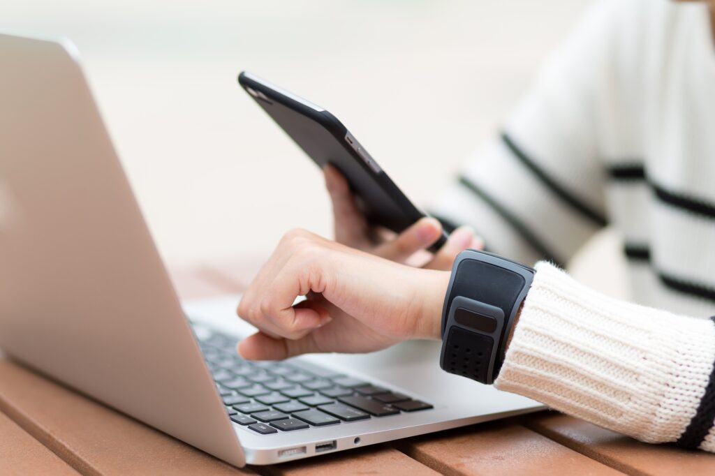 Woman connect the smart watch and mobile phone