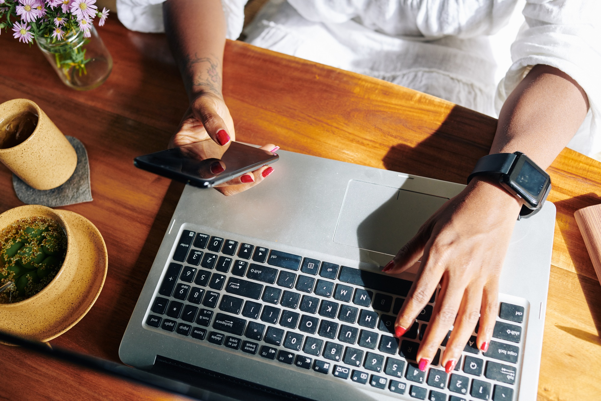 Woman connecting phone with laptop